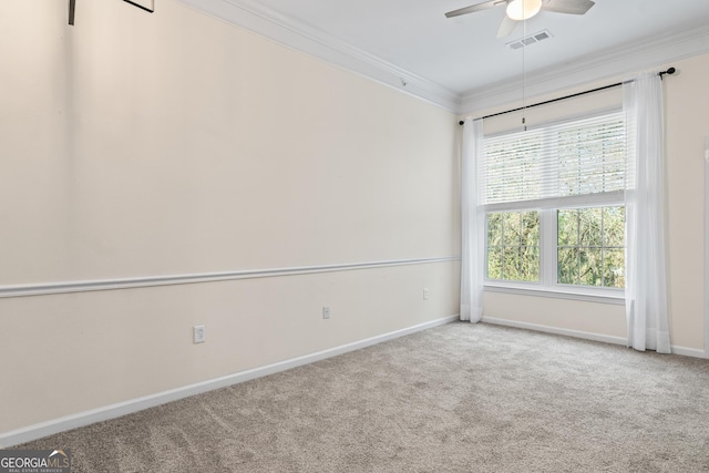 spare room with visible vents, carpet floors, a ceiling fan, and ornamental molding