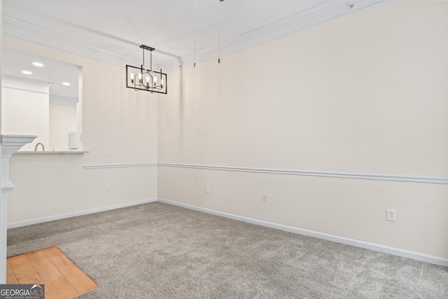 unfurnished dining area featuring a notable chandelier, ornamental molding, recessed lighting, carpet, and baseboards