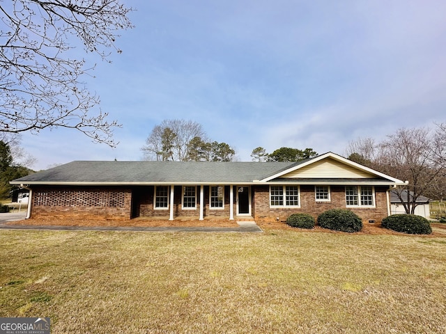 ranch-style home with a front lawn, brick siding, roof with shingles, and crawl space