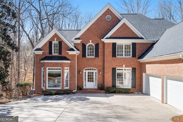 view of front of house with brick siding, roof with shingles, concrete driveway, and an attached garage