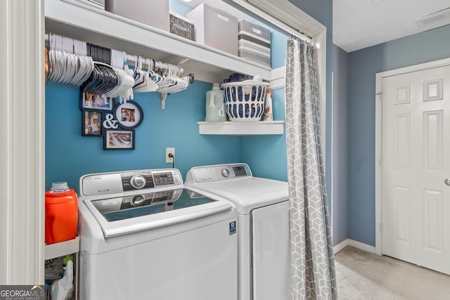 clothes washing area with visible vents, baseboards, carpet, laundry area, and separate washer and dryer