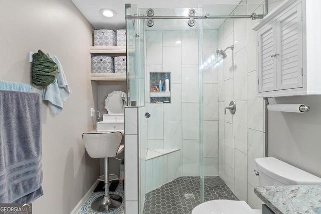 full bathroom with a stall shower, toilet, and baseboards