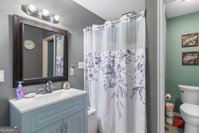 bathroom with a shower with curtain, toilet, and vanity