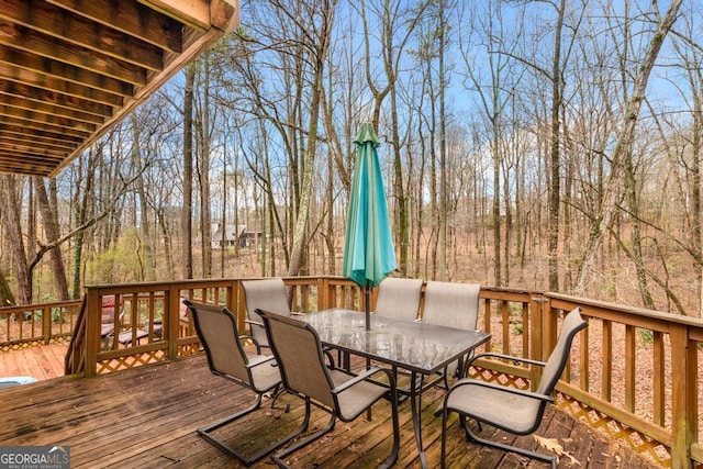 wooden terrace featuring outdoor dining area