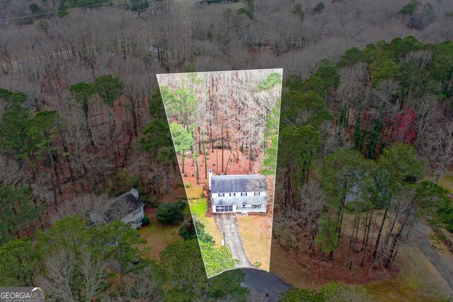 drone / aerial view featuring a wooded view