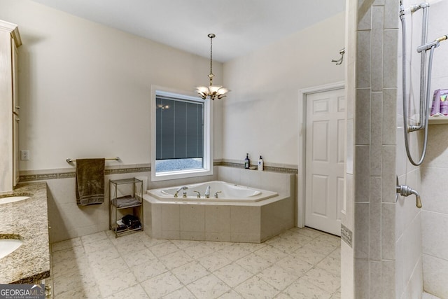 full bath with double vanity, wainscoting, a garden tub, a notable chandelier, and tile patterned floors