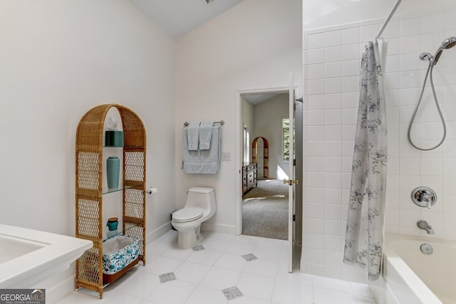 full bath featuring tile patterned flooring, baseboards, toilet, shower / bath combo, and ensuite bathroom