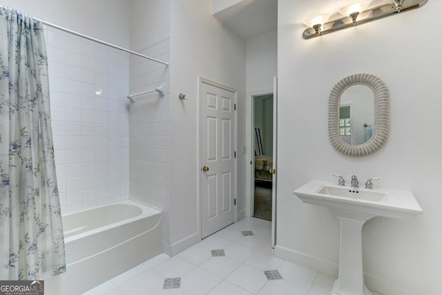 full bath featuring tile patterned flooring, baseboards, and shower / bath combo