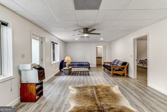 interior space with ceiling fan, baseboards, recessed lighting, wood finished floors, and a paneled ceiling