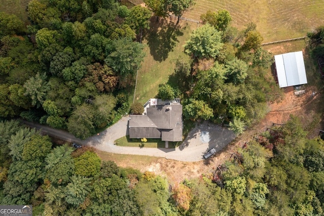 drone / aerial view featuring a forest view