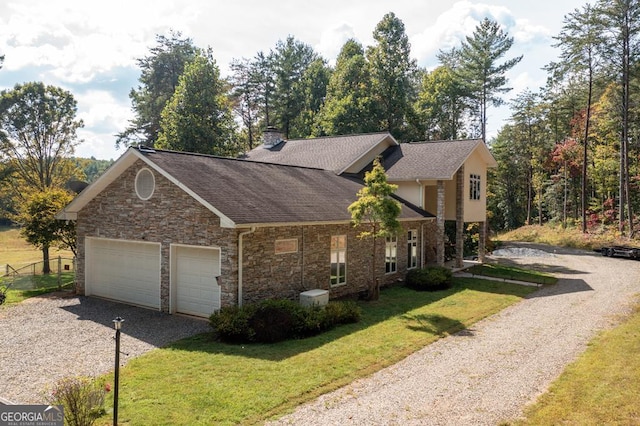 view of home's exterior featuring gravel driveway, a lawn, a garage, and a shingled roof