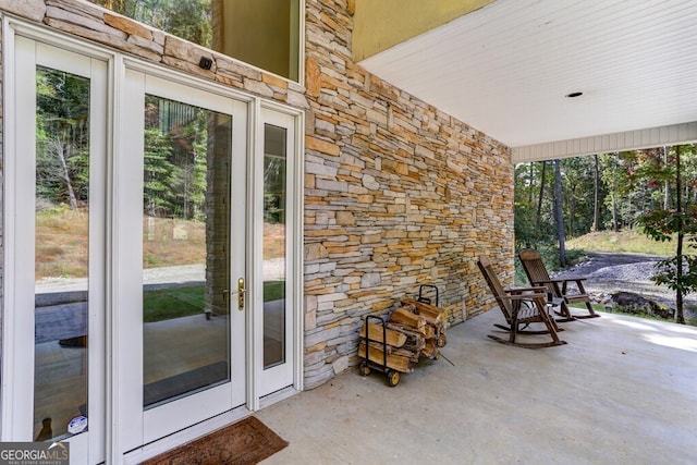 exterior space with unfinished concrete flooring and plenty of natural light