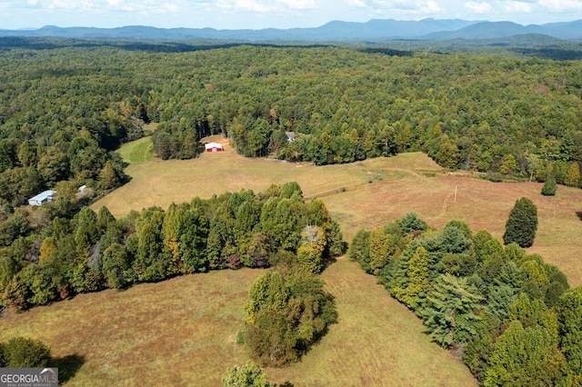 bird's eye view with a mountain view and a wooded view