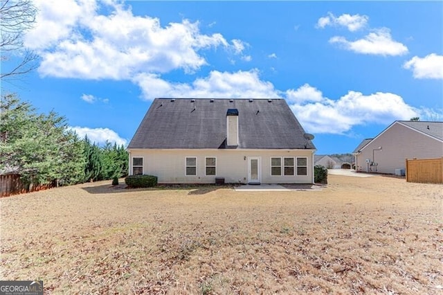 back of property featuring a patio area and fence