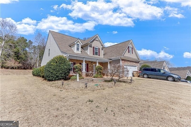 view of front of property with covered porch and a garage