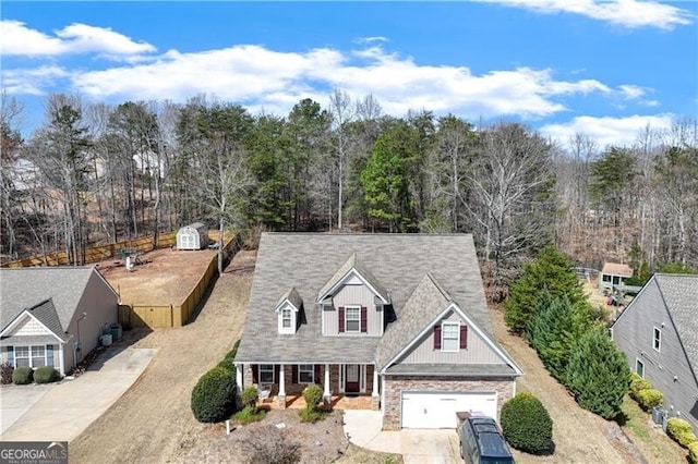 view of front of property with stone siding and driveway