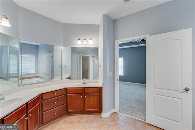 bathroom with a sink, a shower stall, and tile patterned floors