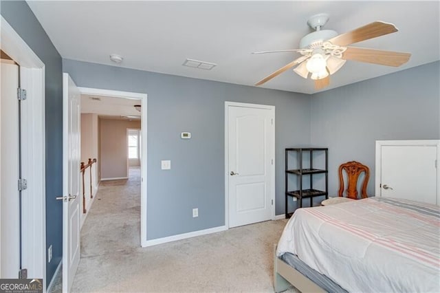 bedroom featuring visible vents, light carpet, baseboards, and a ceiling fan