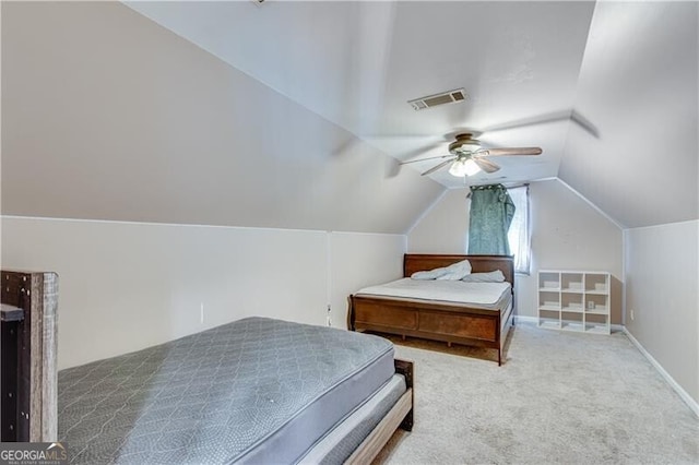 carpeted bedroom featuring visible vents, lofted ceiling, baseboards, and a ceiling fan