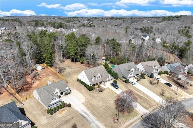 bird's eye view featuring a wooded view