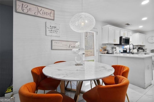 dining area featuring recessed lighting, visible vents, and marble finish floor