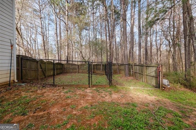 view of yard with a gate and a fenced backyard