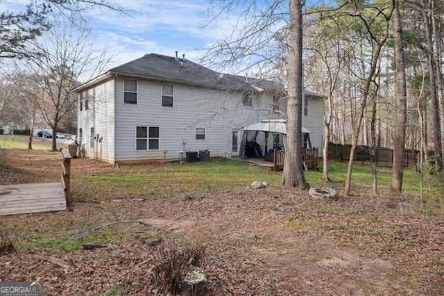 back of property with a deck, a gazebo, and cooling unit