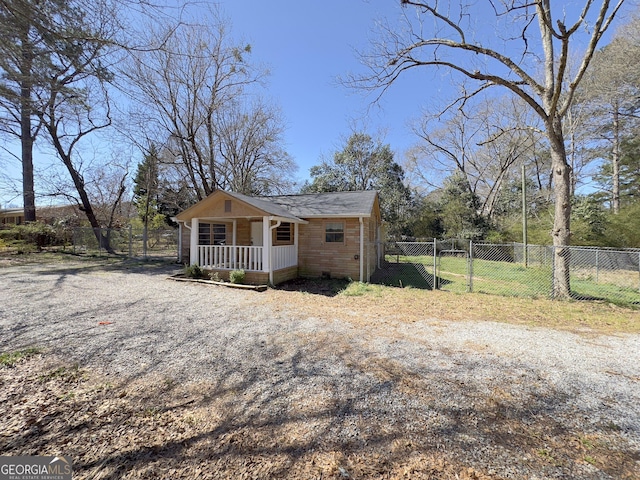 exterior space featuring a gate, fence, and covered porch