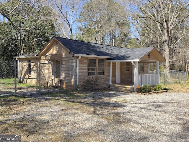 exterior space with a gate, a porch, and fence