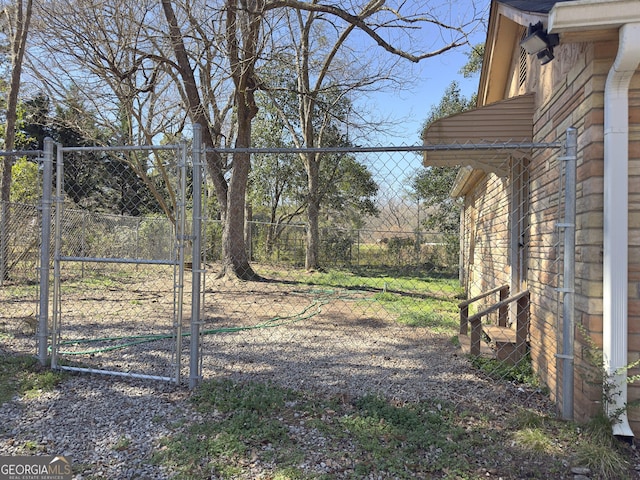 view of yard featuring fence and a gate