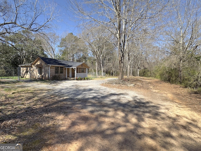 view of home's exterior with dirt driveway