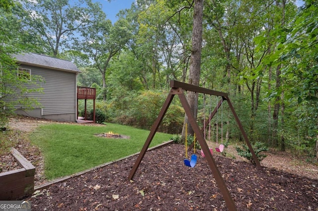 4125 Gables Pl, Buford, GA 30519 - view of grassy yard featuring a deck, a fire pit, and a playground