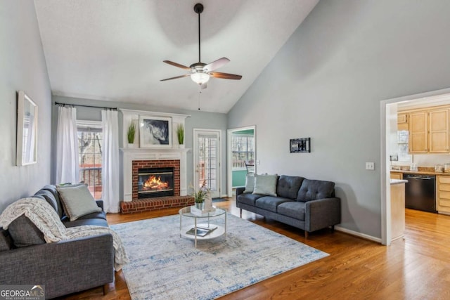4125 Gables Pl, Buford, GA 30519 - living area featuring high vaulted ceiling, a ceiling fan, a brick fireplace, and light wood-style flooring