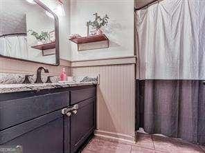 full bathroom featuring tile patterned floors and vanity