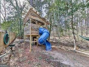 view of jungle gym featuring fence