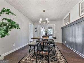 dining room featuring baseboards and an inviting chandelier