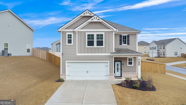 craftsman-style house with fence, board and batten siding, concrete driveway, a garage, and brick siding