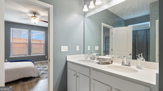 bathroom with wood finished floors, ceiling fan, and a sink