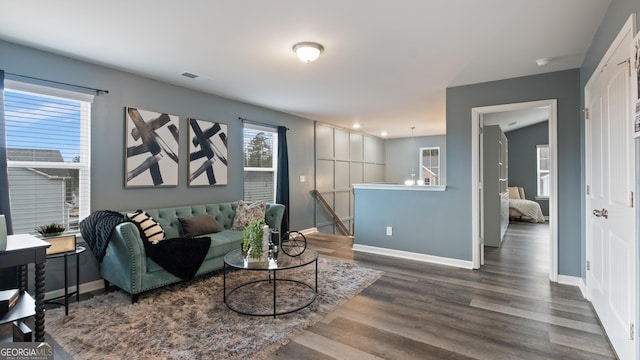 living area with visible vents, recessed lighting, baseboards, and wood finished floors