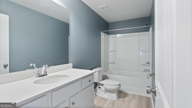 full bath featuring vanity, wood finished floors, visible vents, shower / tub combination, and toilet