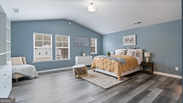 bedroom featuring visible vents, baseboards, wood finished floors, and vaulted ceiling