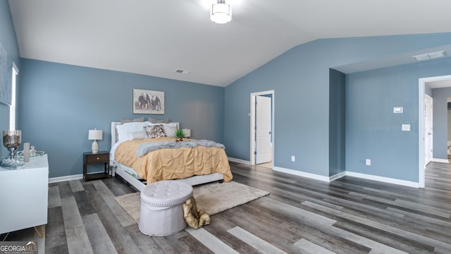 bedroom featuring visible vents, baseboards, lofted ceiling, and wood finished floors