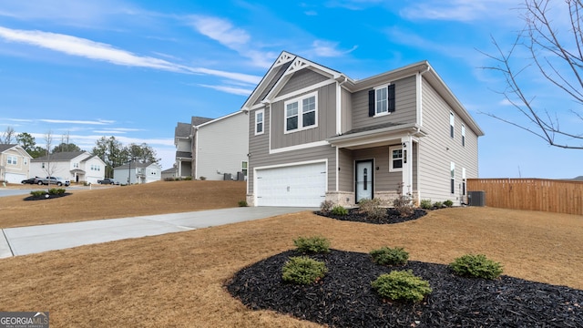 view of front of property with fence, driveway, an attached garage, a front lawn, and a residential view