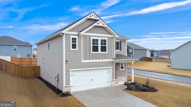 craftsman-style home with board and batten siding, concrete driveway, a garage, and fence