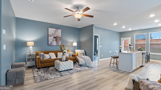 living room featuring recessed lighting, baseboards, light wood-style flooring, and a ceiling fan