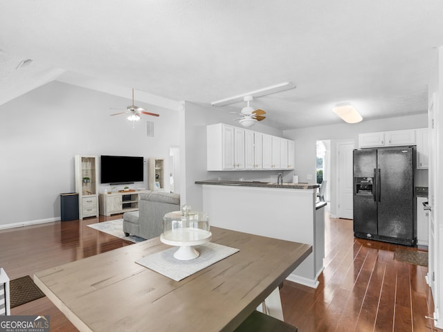 dining space with lofted ceiling, dark wood finished floors, and a ceiling fan