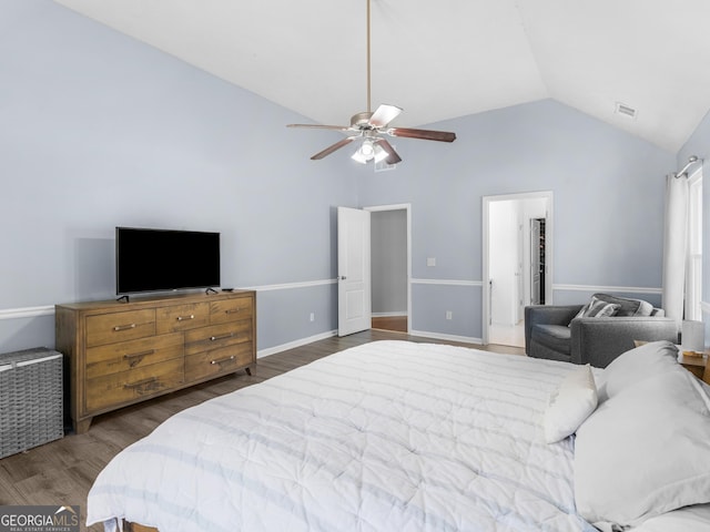 bedroom with wood finished floors, baseboards, visible vents, lofted ceiling, and ceiling fan