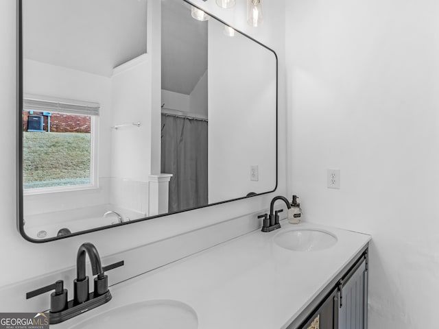 bathroom with double vanity and a sink