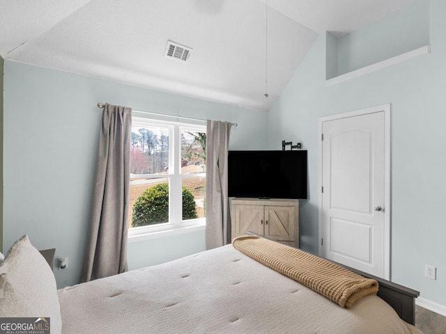 bedroom with lofted ceiling, baseboards, and visible vents