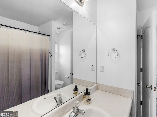 bathroom featuring vanity, toilet, and a shower with curtain